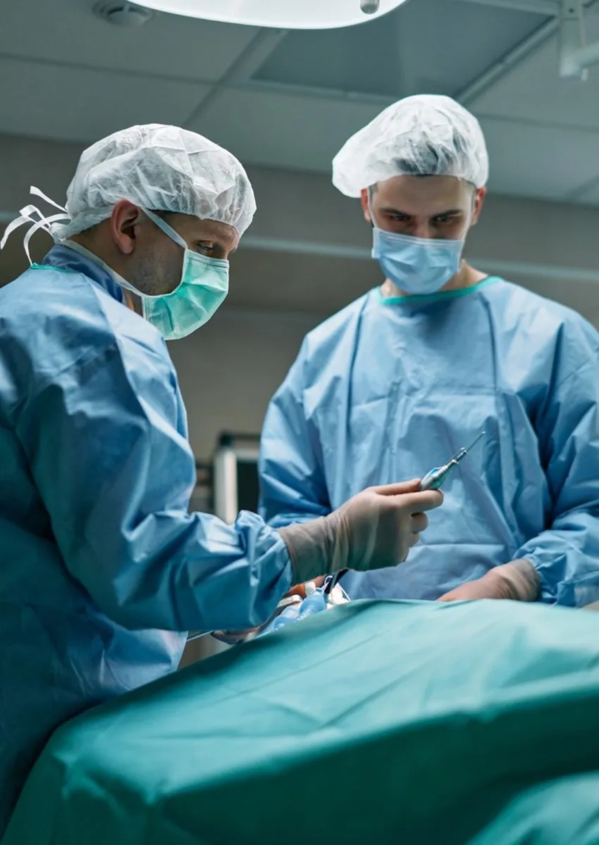 Surgeon demonstrates surgical equipment in the operating room